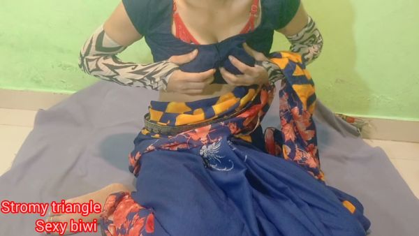 Woman with orange hair spreads her shaved vulva on a gray cloth against a green wall - India on breastful.com