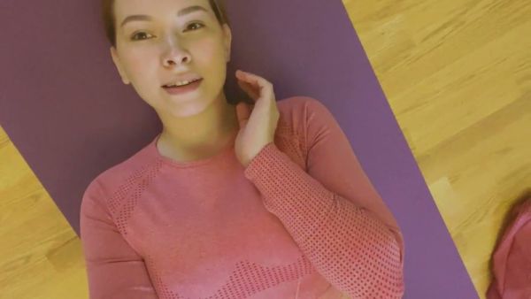 Young teen stretches into intimate yoga poses on her purple mat on breastful.com