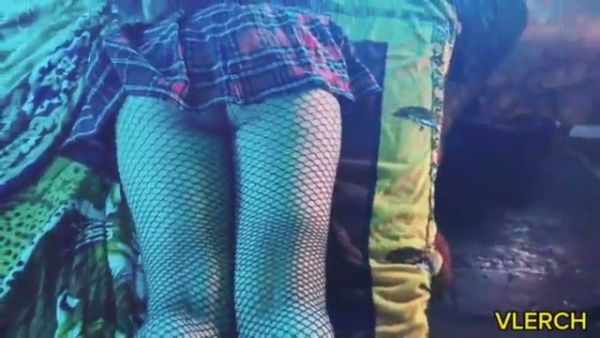 Young Latina otaku teases in fishnets and plaid under blue neon light on breastful.com