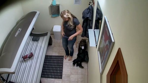 Blonde MILF prepares for a solarium session in her private hallway on breastful.com