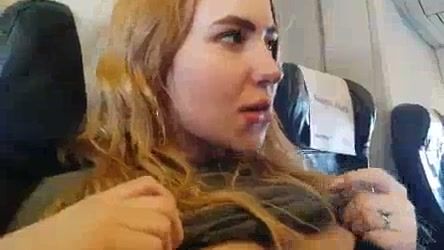 Blonde gives a discreet handjob during a flight in plain sight on breastful.com