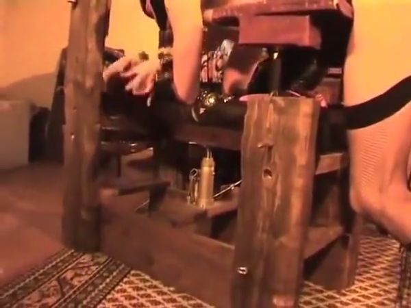 Strict latex-clad mistress disciplines her submissive with the whip in a rustic dungeon on breastful.com