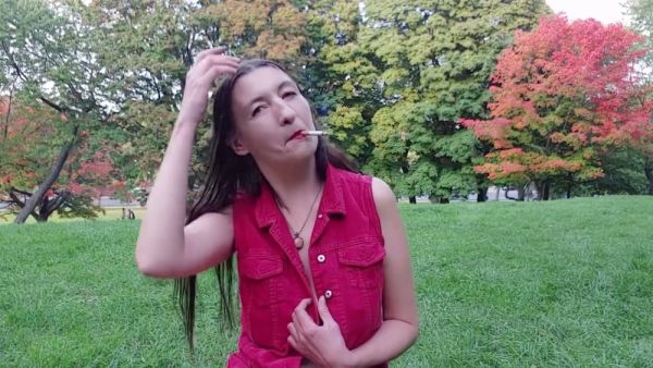 Gypsy Dolores bares it all in a red shirt while smoking in an autumn park on breastful.com