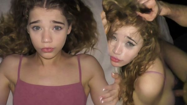 Curly-haired college girl takes cumshot deep in her mouth on a dimly lit bed on breastful.com
