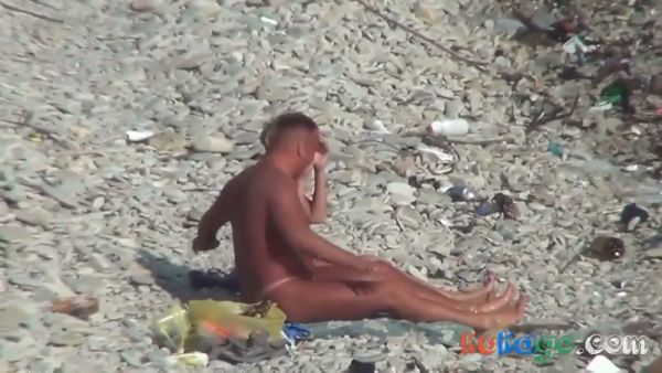 Tanned couple in pink thongs take their anal play to a rocky public beach on breastful.com