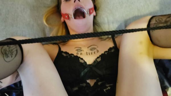 Tattooed submissive in black lace lingerie takes a deep throat with ball gag on breastful.com