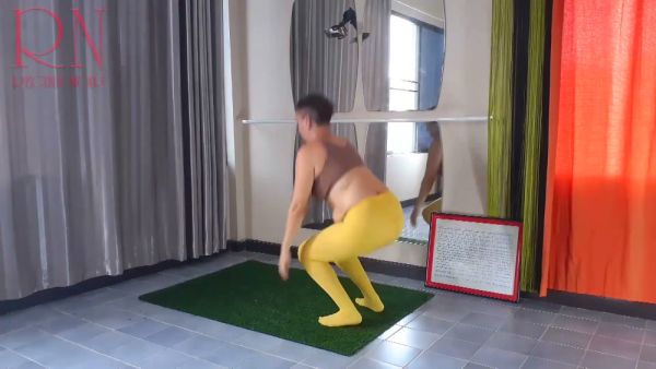 Regina Noir stretches in yellow leggings during a private yoga session at the gym on breastful.com