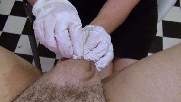 Dominant nurse torments a man's cock and balls in a clinical fetish session on breastful.com
