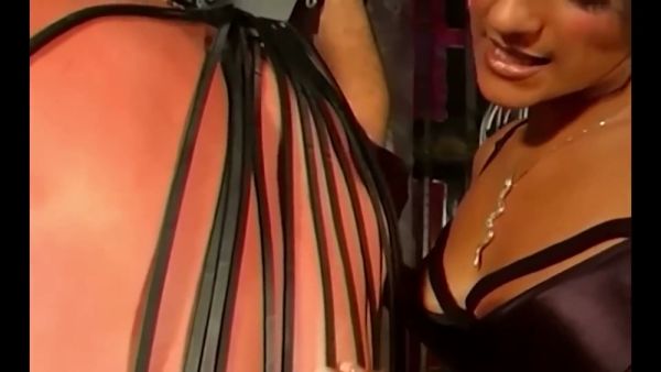 Mistress Delilah commands her leather-clad submissives in a dungeon session on breastful.com