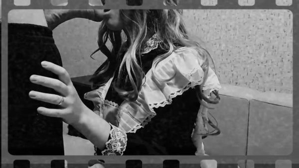 French maid in black and white poses on a sofa with book - France on breastful.com