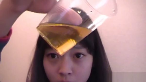 Young Asian performer sips golden fluid in intimate bathroom session on breastful.com