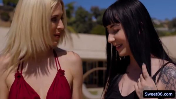 Gothic woman in black stockings embraces her blonde lover outdoors on breastful.com