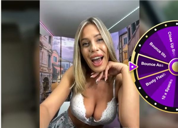 Blonde woman in white lace bra slowly reveals her large natural breasts in a selfie session on breastful.com
