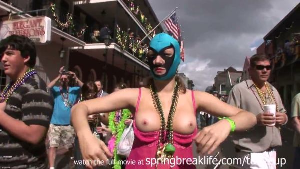 Mature blonde teases exposed during Mardi Gras street parade on breastful.com