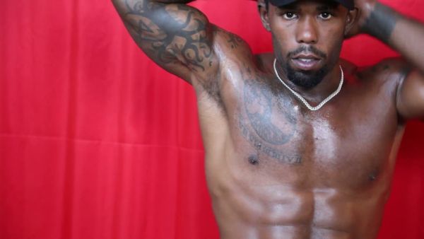 Muscular black man in cap gives handjob commands with dominant presence on breastful.com