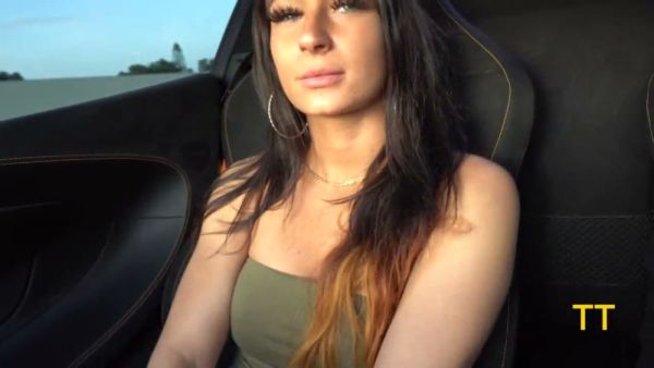 Alessia Luna kneels before Teddy Tarantino's McLaren for a rough outdoor handjob on breastful.com