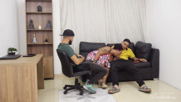 Tattooed woman worships one man while taking another deep from behind on a leather sofa on breastful.com
