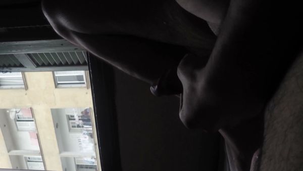 Alone in a hotel room, a figure masturbates at the window watched by an elderly neighbor on breastful.com