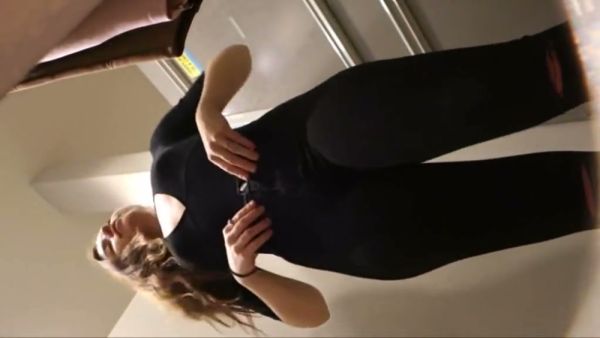Slender brunette in tight pink leggings caught on camera during a fitting session on breastful.com