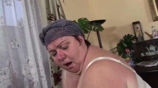 BBW woman pleasures herself with an anal toy before welcoming a man on the couch on breastful.com