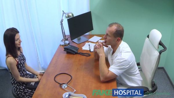 European doctor in white coat treats his patient with oral care on the exam table on breastful.com