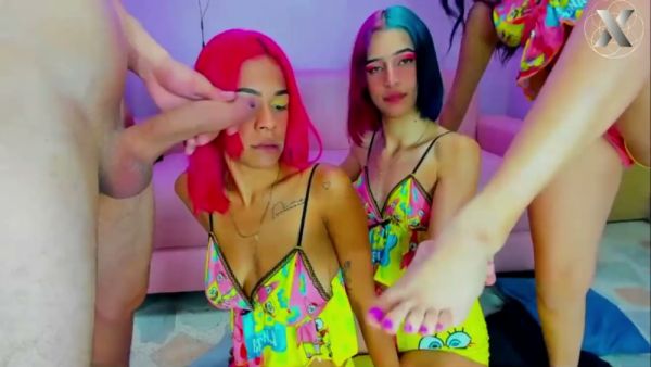 Three women with colorful hair in cartoon dresses take turns on a man's cock on breastful.com