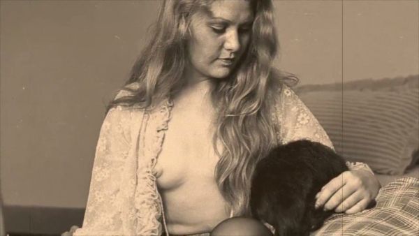 Vintage blonde receives oral sex from shirted man on a patterned bed on breastful.com