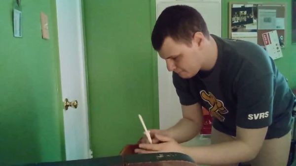 Man prepares an enema in diaper briefs with buttocks exposed in a green room on breastful.com