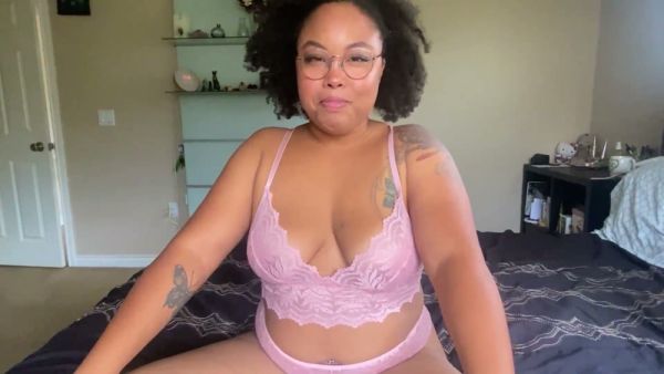 Curvy ebony woman in glasses gives firm jerk off commands from bed on breastful.com