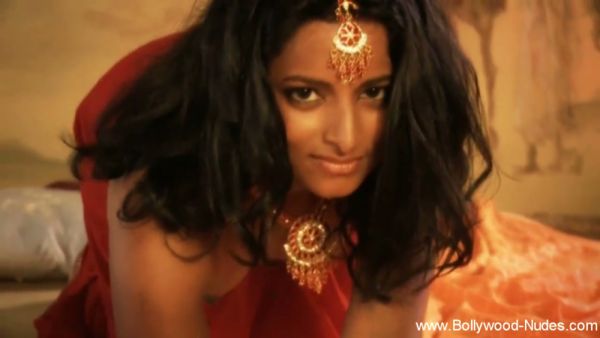 Dark-haired Indian mistress glows in red silk and gold under warm candlelight - India on breastful.com