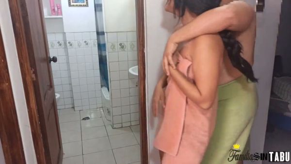 Wet skin glistens in the bathroom as a couple shares an intimate moment after showering on breastful.com
