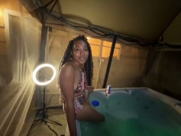 Dark-haired Jamaican beauty bares her curves alone in a glowing hot tub on breastful.com