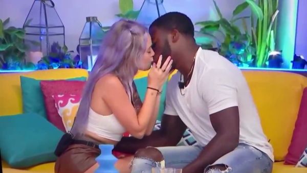 Passionate kisses exchanged between couples on a vibrant TV set on breastful.com