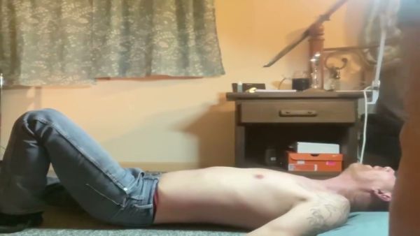 Bound and trampled under her feet in a dim bedroom on breastful.com