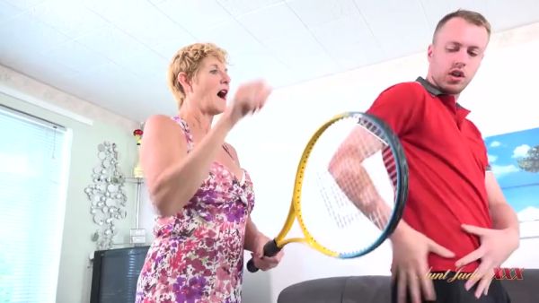 Amateur encounter between a blonde housewife and her young tennis instructor escalates in the living room on breastful.com