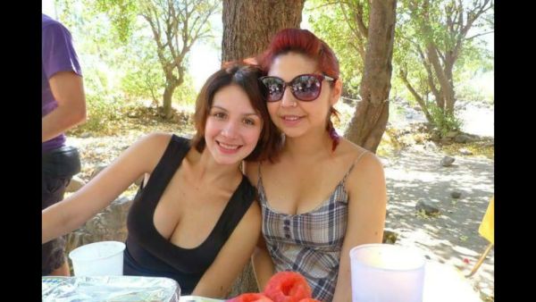 Chilean woman poses seductively with large breasts and full hips in intimate settings on breastful.com