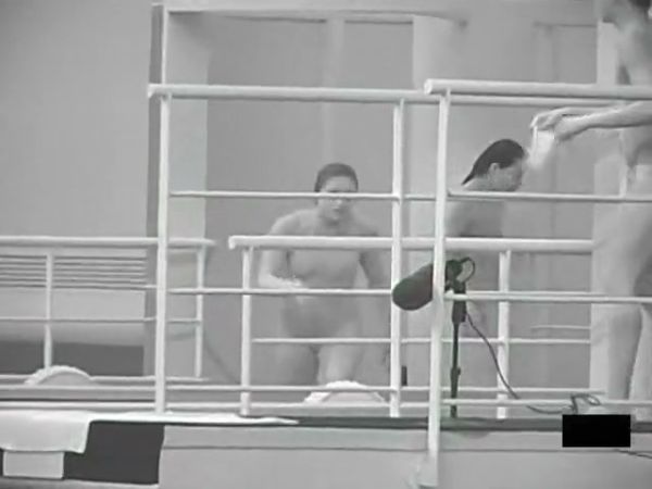 Monochrome study of nude figures in motion within an indoor gym and dance space on breastful.com