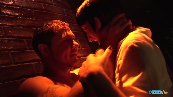 Tattooed lovers entwine in lingerie against dim brick walls under neon lights on breastful.com
