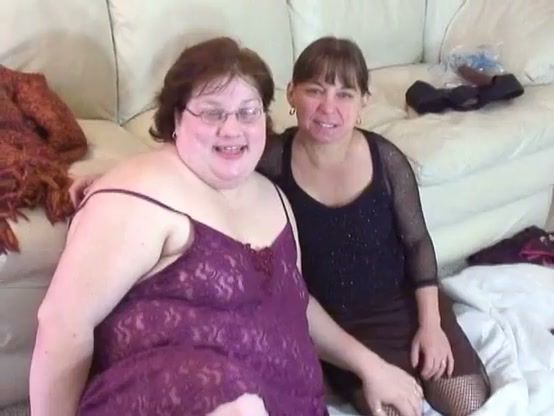 Curvy glasses-wearing woman pleasures her partner with a strapon in intimate setting on breastful.com