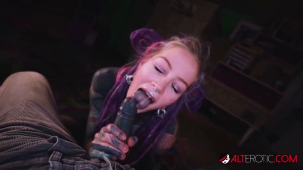 Tattooed woman with purple dreadlocks gives oral to a dark-skinned man in POV on breastful.com