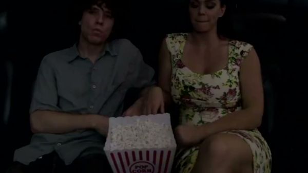 Mature brunette gives a stealthy handjob in a dark cinema on breastful.com
