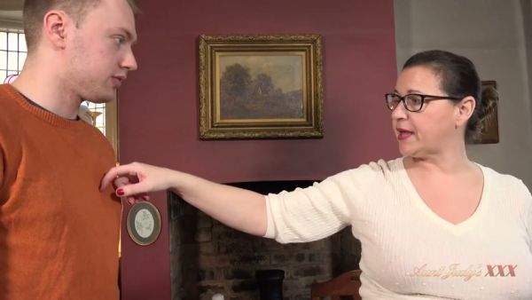 Elegant mature woman in glasses meets her young colleague for an intimate office encounter on breastful.com
