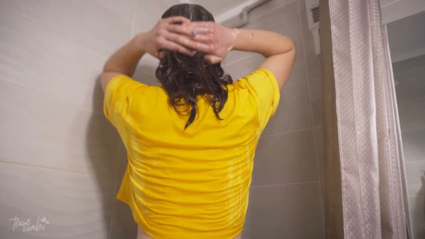 Curvy woman teases in sheer pantyhose and wet yellow shirt in bathroom on breastful.com
