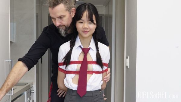 Young Japanese student in school uniform tied up and suspended in a narrow hallway - Japan on breastful.com