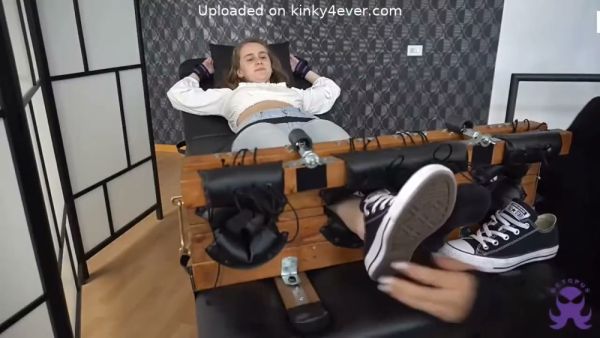 Bound brunette undergoes intense foot tickling session on restraint bench on breastful.com