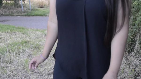 South Asian British woman stands on a grassy path in a quiet public park - India - Pakistan - Britain on breastful.com