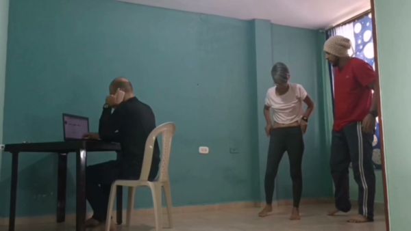 Mature Spanish-speaking men share a quiet moment in a colorful room with teal walls on breastful.com