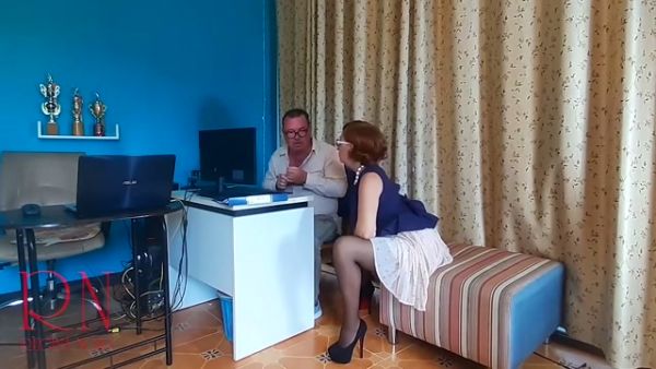 Redheaded office dominatrix humiliates her kneeling employee with foot worship on breastful.com